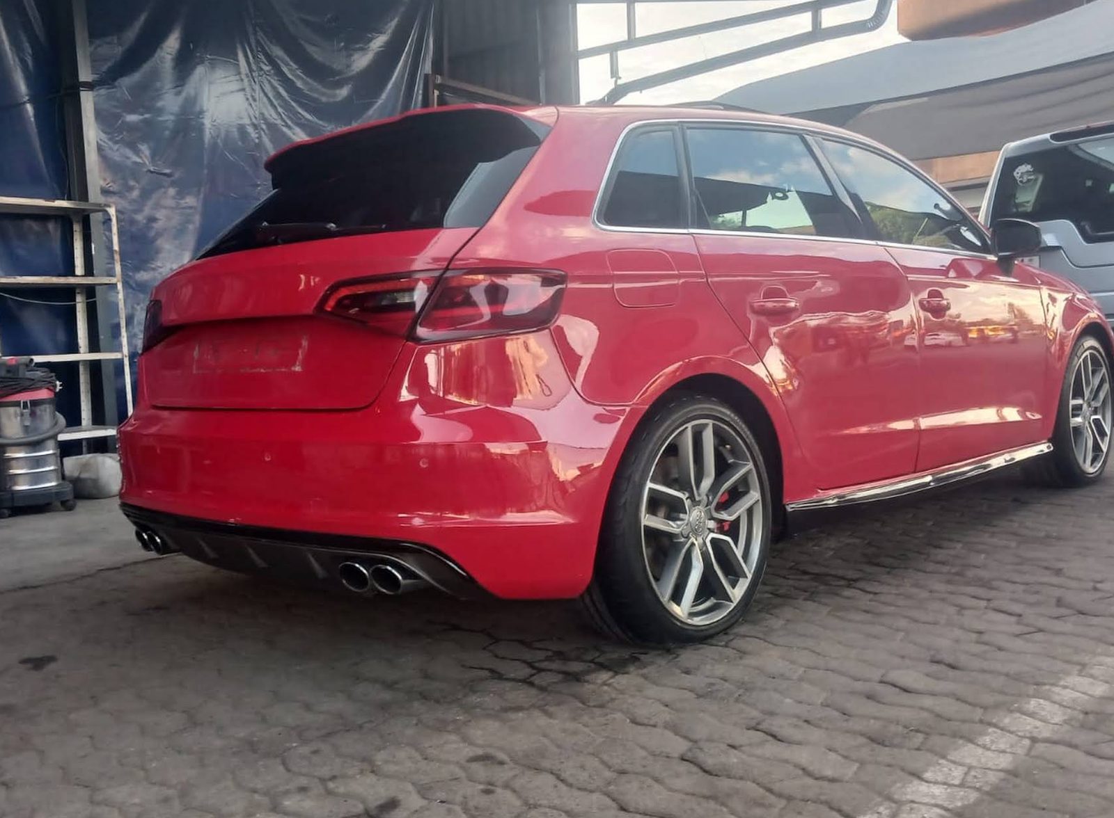 Red Audi S3 Sportback parked in the Corner Car Repairs yard