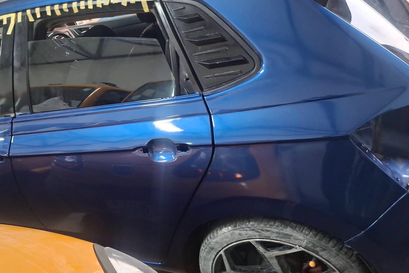 The same Polo GTI after panel work and paint, rear door and quarter panel finished in blue